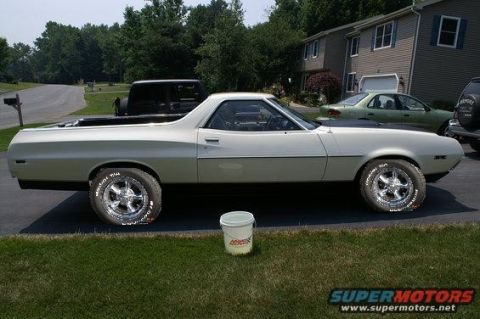 1972 Ford Ranchero - Driver-side profile of a cream-white Ford Ranchero parked in a driveway, fitted with polished five-spoke aluminum wheels and raised-white-l…