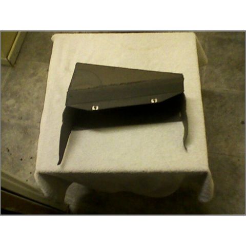 1972 Ford Ranchero - A dark-colored automotive part is displayed on a table, its purpose and origin unclear from the image.