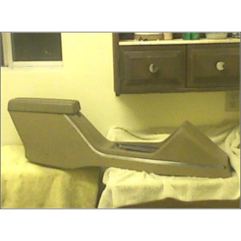 1972 Ford Ranchero - A tan automotive center console with an armrest sits on a table.