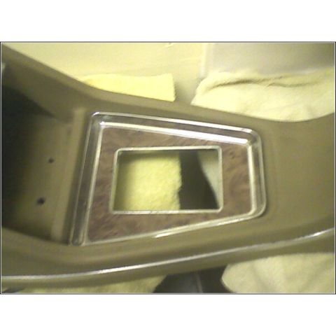 1972 Ford Ranchero - Close-up of a vehicle's interior dashboard trim a wood grain pattern and chrome accents.