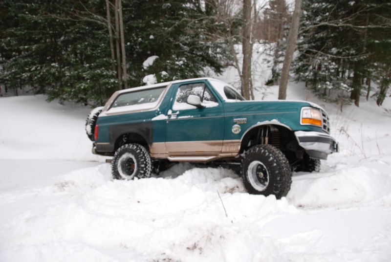 1996 Ford Bronco with lifted suspension stuck in snow, side view