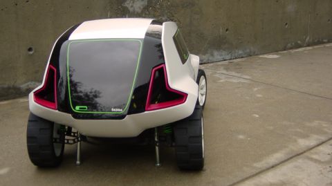 1993 Ford Probe - Rear view of a white concept car distinctive pink and green accents on its taillights and rear window trim.