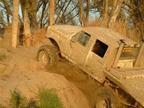 1992 Ford F-350 - Muddy 1992 Ford F-350 navigates a challenging off-road terrain.