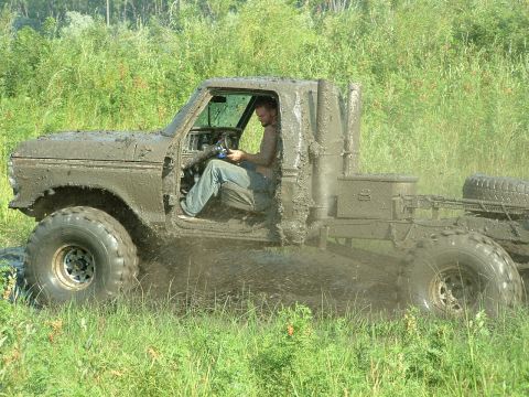 1992 Ford F-350 - This heavily modified 1979 Ford F-350 is shown off-roading through a muddy field.