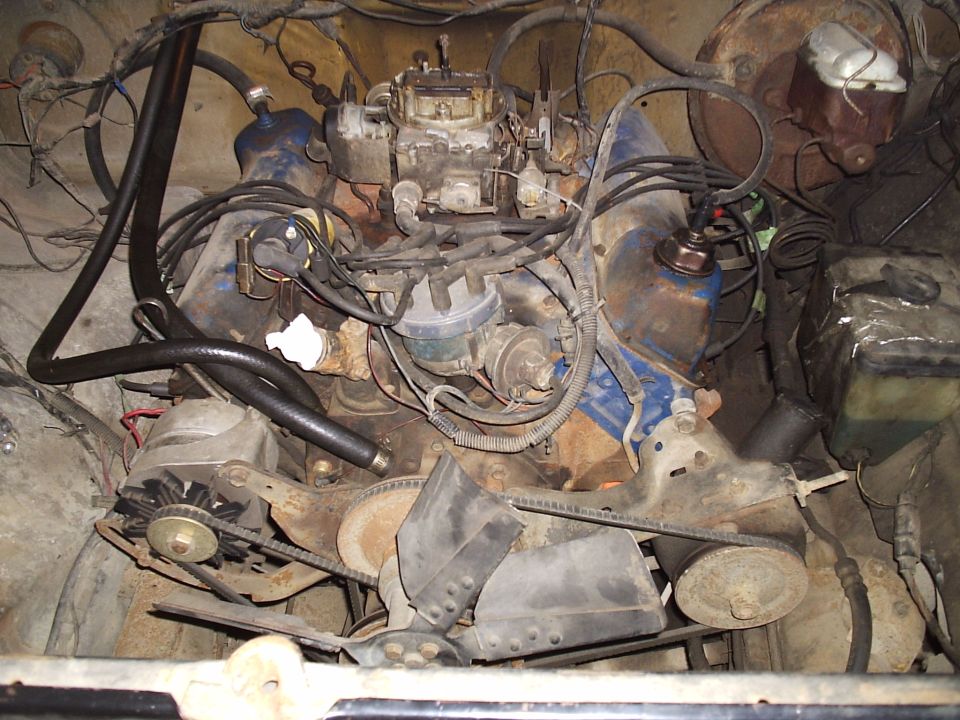 Ford V8 engine with carburetor, distributor, and alternator visible