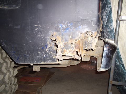 1979 Ford Bronco - Significant rust damage is visible on the lower rear quarter panel of the vehicle, indicating structural compromise.