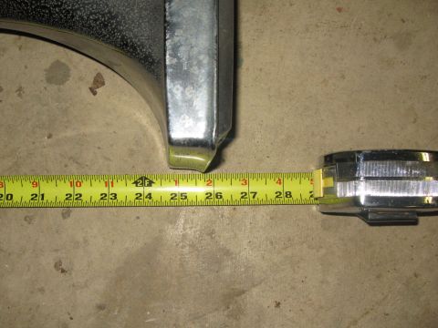 2007 Ford Bronco - A close-up shot of a chrome bumper section being measured with a tape measure.
