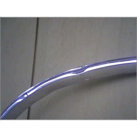 1972 Ford Ranchero - Close-up of a damaged chrome trim piece, likely from a vehicle.