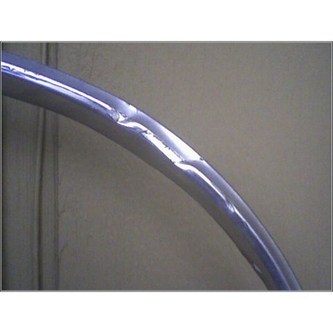 1972 Ford Ranchero - Close-up of damaged chrome trim, possibly from a vehicle part.