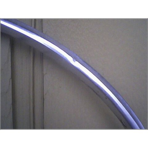 1972 Ford Ranchero - A bent chrome trim piece is shown against a textured background.