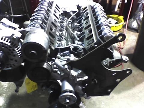 1991 Ford Mustang - Close-up view of an engine assembly with various components attached.