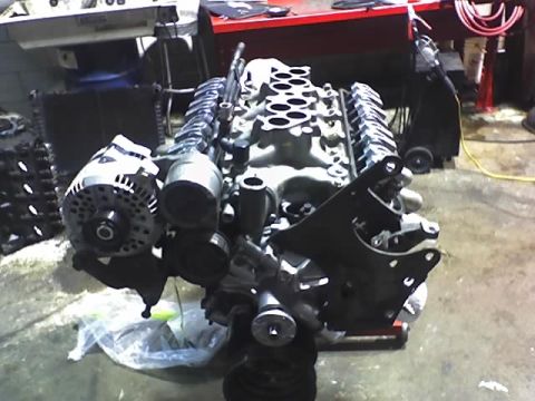 1991 Ford Mustang - Engine assembly, likely a V8, with an alternator and intake manifold visible. The registry claims it is a 1991 Ford Mustang, but this is un…