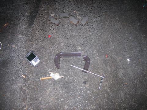 1987 Volkswagen Scirocco - Tools and a cell phone are laid out on a dark, textured surface.