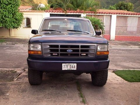 1995 Ford F-150 - Front view of a dark blue Ford truck, identified as a 1992 model based on its grille.