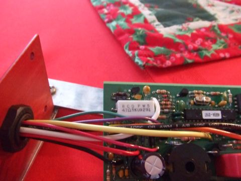 1995 Ford Mustang - A close-up view of an electronic circuit board and wiring harness, with a festive fabric visible.
