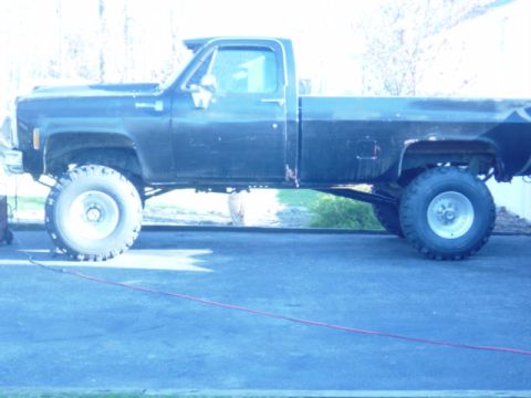 1987 Suzuki Samurai - This lifted pickup truck, likely from the late 1970s or early 1980s, is shown from the side.