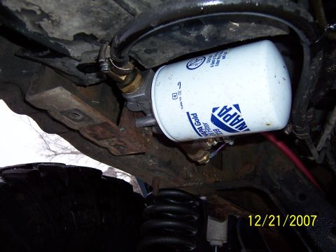 1994 Ford Bronco - Close-up of an oil filter and suspension components on a vehicle.