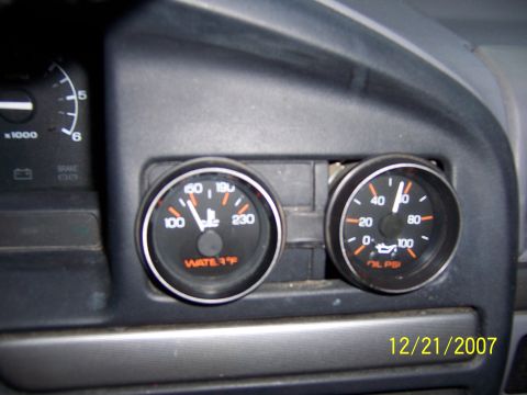 1994 Ford Bronco - Close-up of the interior dashboard showing water and oil pressure gauges.