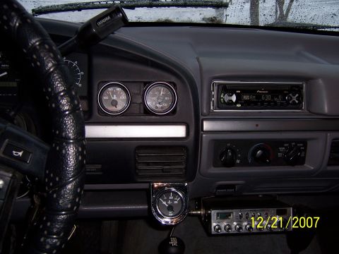 1994 Ford Bronco - The interior of a vehicle shows a dashboard with multiple gauges, a Pioneer stereo, and a CB radio unit.