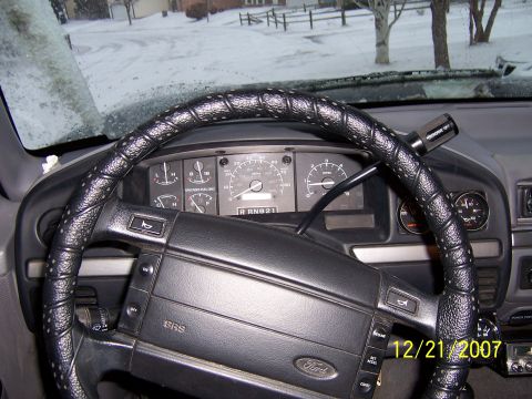 1994 Ford Bronco - Interior view of a 1994 Ford Bronco on a snowy day, with dashboard and steering wheel visible.