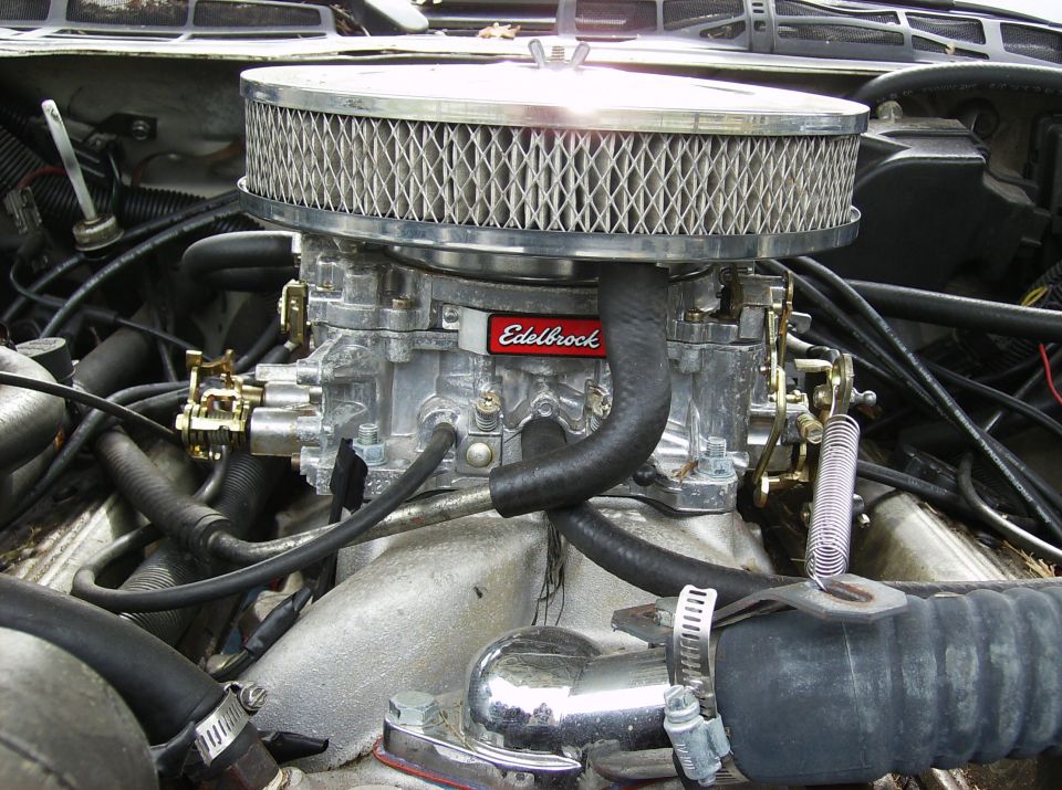 Close-up of an Edelbrock carburetor with a chrome air filter housing