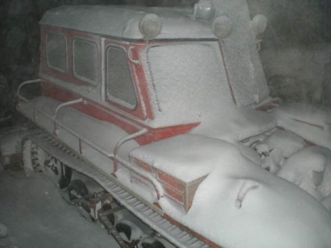 2000 Ford E350 - A snow vehicle is covered in a thick layer of snow, obscuring its details.