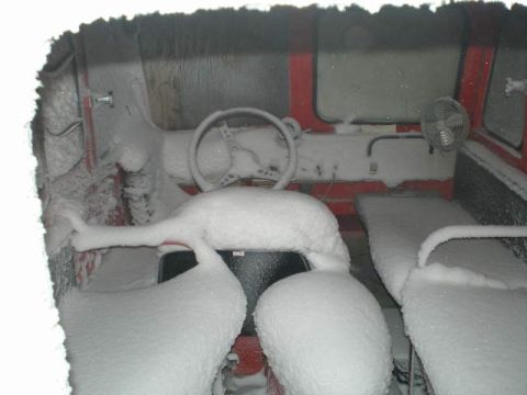 2000 Ford E350 - Vehicle interior completely buried in snow, obscuring most details.
