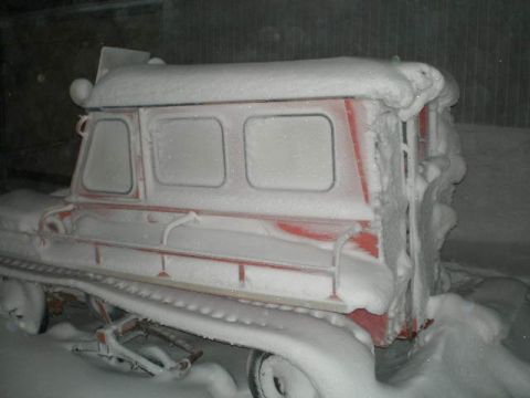 2000 Ford E350 - This unusual tracked vehicle is heavily covered in snow, obscuring most of its details.