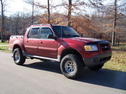 2002 Ford Sport Trac - This red 2002 Ford Sport Trac features a lifted suspension and off-road tires, ready for adventure.