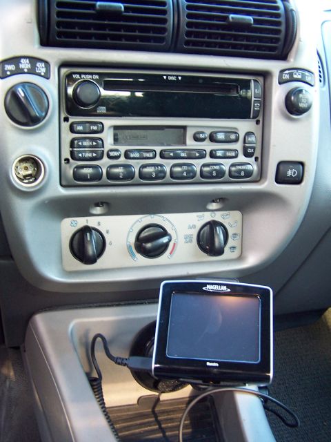 2002 Ford Sport Trac - Center console of a 2002 Ford Sport Trac, a radio, climate controls, and a mounted GPS device.