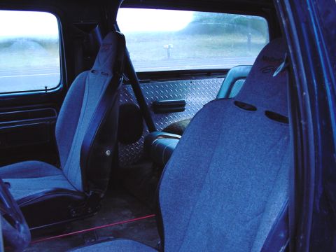 1979 Ford Bronco - The interior of this 1979 Ford Bronco features racing seats and custom diamond plate paneling.