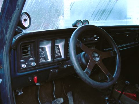 1979 Ford Bronco - Interior view of a 1979 Ford Bronco showing aftermarket gauges and steering wheel.