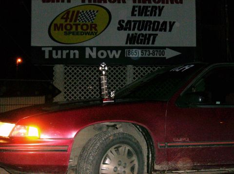 1995 Ford Probe - Trophy on the hood of a red sedan, with '97 visible on the trophy.