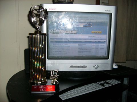 1995 Ford Probe - Computer setup with a trophy and a website for car enthusiasts displayed on the monitor.