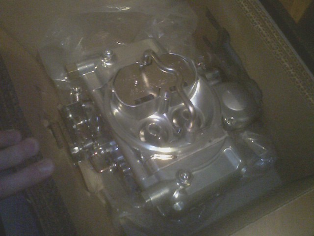 Chrome carburetor in plastic packaging inside a cardboard box