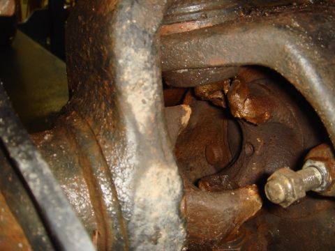 1996 Ford Bronco - Close-up view of heavily corroded and damaged vehicle suspension components.