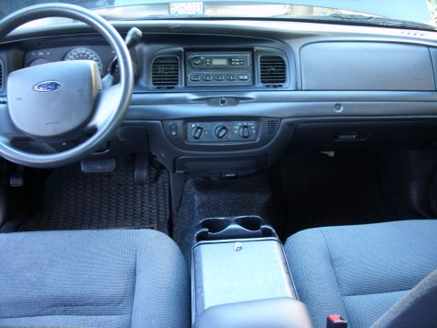 2005 Ford Crown Victoria - The interior of a 2005 Ford Crown Victoria, the dashboard, steering wheel, and front seats.