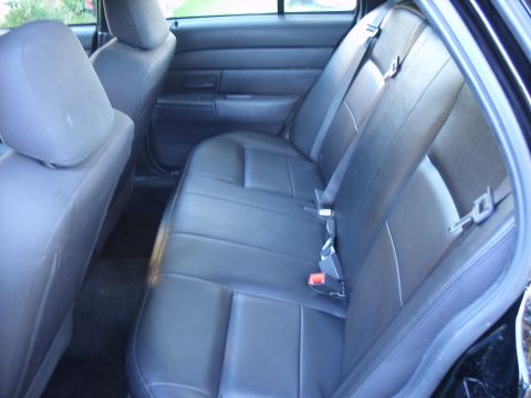 2005 Ford Crown Victoria - View of the rear interior of a vehicle, showing the seats and door panel.