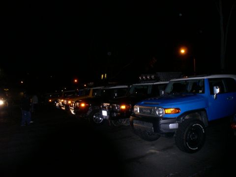 2007 Toyota FJ Cruiser - Several Toyota FJ Cruisers parked in a line at night, with a blue one prominently displayed.