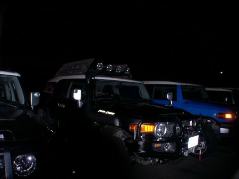 2007 Toyota FJ Cruiser - Multiple Toyota FJ Cruisers are parked together at night, illuminated by their headlights and roof lights.