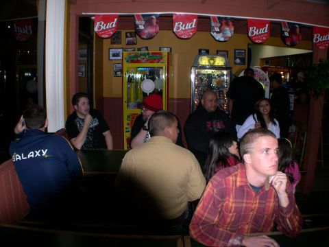 2007 Toyota FJ Cruiser - A group of people are seated at tables inside a bar, with Budweiser banners hanging from the ceiling.