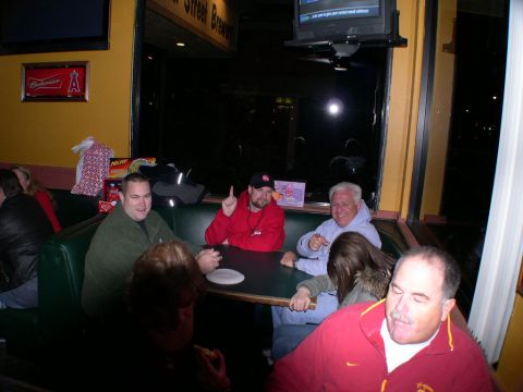 2007 Toyota FJ Cruiser - People gather around a table in a dimly lit restaurant booth, enjoying a meal and conversation.