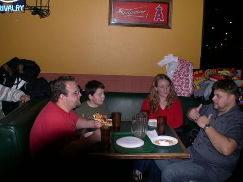 2007 Toyota FJ Cruiser - Friends and family gather around a table in a restaurant, enjoying pizza and conversation.