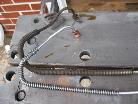 1968 Shelby GT500 - Close-up of brake lines, one showing significant wear and corrosion, the other appearing new.