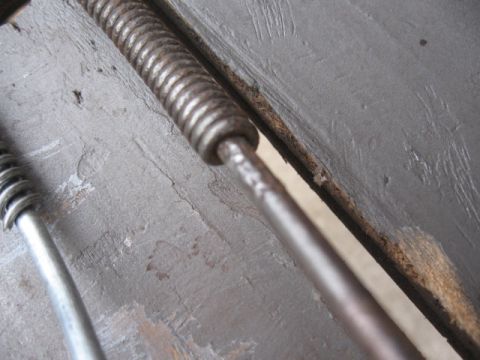 1968 Shelby GT500 - Detail of a metal rod and spring, possibly from a vehicle's suspension system.