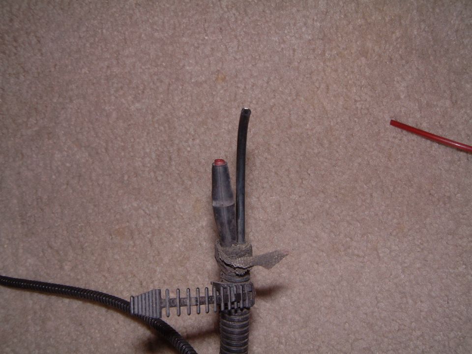 i believe this black line goes to the coffee can on the passenger side fender....but there's also a nutty 2-to-1 connector which joins 2 red lines into a single red line