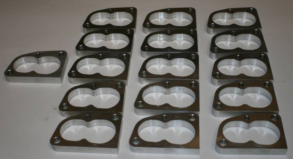 Multiple aluminum throttle body spacers arranged in rows