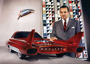 1972 Ford Ranchero - A man poses with a futuristic red concept car prominent tail fins and a unique front grille.