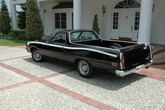 Black 1972 Ford Ranchero with white side stripe, parked in driveway