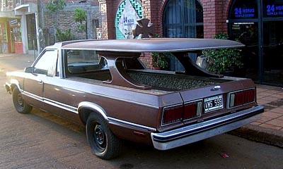 1972 Ford Ranchero - This modified vehicle appears to be a hearse conversion with a distinctive cross ornament on its roof.